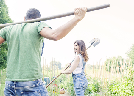 young couple go to work in your gardenの写真素材