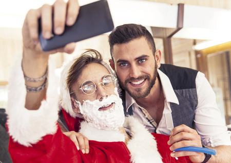 Santa Claus takes a Selfie with your barberの写真素材