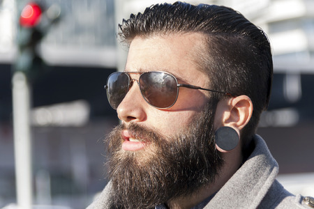 portrait of young hipster businessman in the heart of city