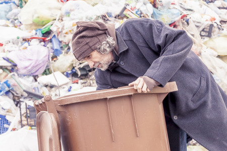 homeless rummages in the dustbin of landfillの写真素材