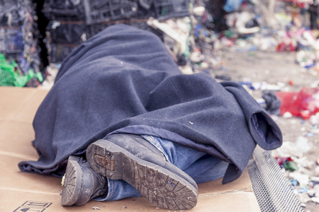 homeless man sleeps in the waste on a wire mesh of bed
