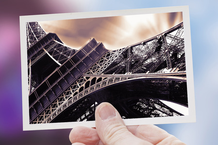 hand shows a shot of paris with landmark eiffel towerの写真素材