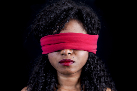 portrait of young african american female with a red blindfold onの写真素材