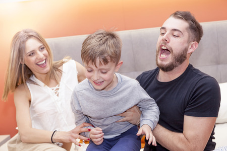 child jokes with parents on the bed in the morningの写真素材