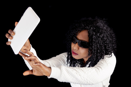 young african american girl in white sweater takes a selfie