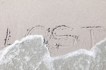 written on wet sand by the wavesの写真素材
