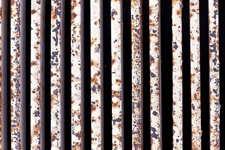 rusty and scratched metal gate backgroundの写真素材