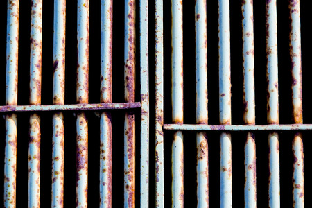 rusty and scratched metal gate backgroundの写真素材