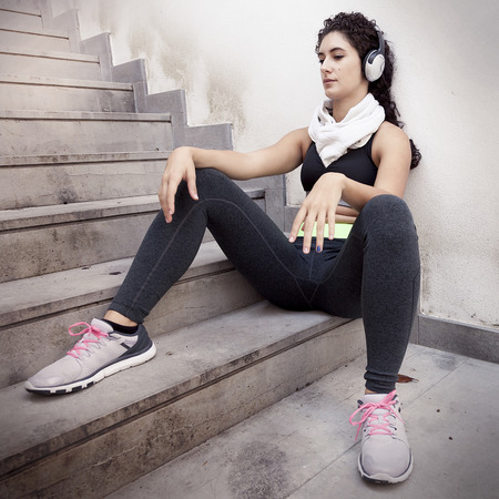 young female runner relaxing listening to music from headphonesの写真素材