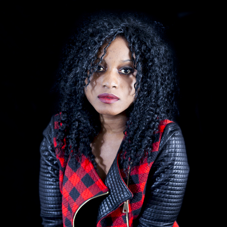 portrait of beautiful young african american girl wearing leather jacket