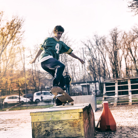 young skateboarder jumping on a ramp outdoorの写真素材