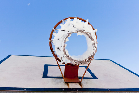 basketball backboard on blue sky outdoor in the snowy parkの写真素材