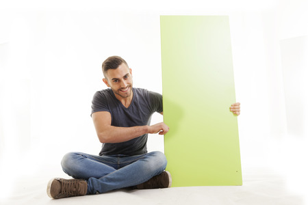 portrait of young man showing sign isolated on whiteの写真素材
