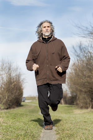 adult sportsman  running and jumping natural obstacles outdoorsの写真素材