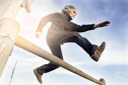 adult sportsman  running and jumping natural obstacles outdoorsの写真素材