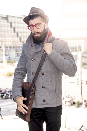 young hipster businessman consults his laptop in the heart of cityの写真素材