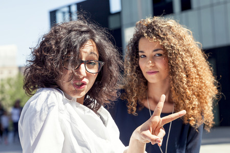 portrait of two beautiful arabian girls relaxing during a vacation in milanの写真素材