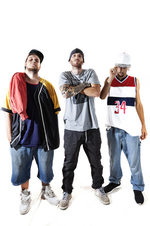 group of three rappers posing in the photographic studio on white backgroundの写真素材
