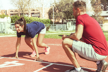 the coach times and gives tips for the ride to his young runner athlete with the tablet