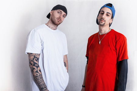 portrait of two rapper friends in the studio on a white background