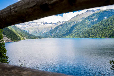 view of a beautiful lake surrounded by the dolomites mountain range in summertimeの写真素材
