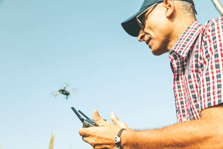 modern technological farmer analyzing the growth of corn by flying a drone over his cultivated fields. concept of sustainable exploitation of natural resources.の写真素材