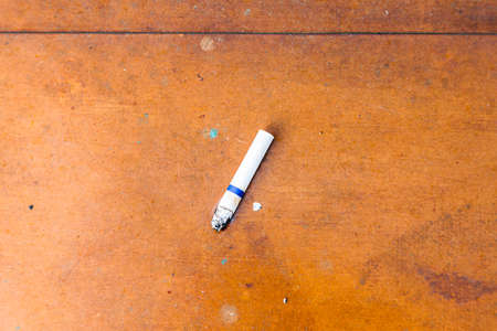 cigarette butt rusty and scratched metal panel background. old rusty textureの写真素材