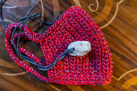 red handmade fabric mask to defend against the coronavirus pandemicの写真素材