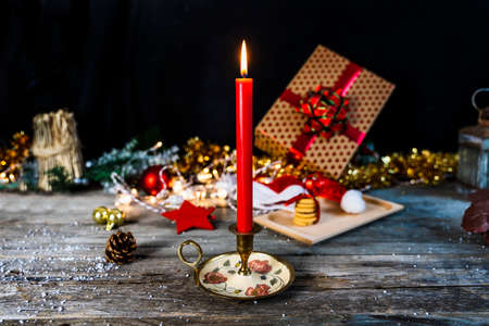 christmas decoration lights with gift and three cookies on wooden table. concept of Christmas atmosphereの写真素材