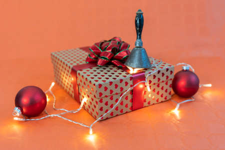 christmas gift and decorative lights on orange background. concept of Christmas atmosphereの写真素材