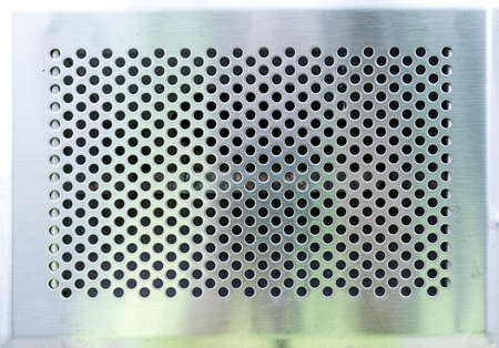 matte metal panel covered with holes to use as a background