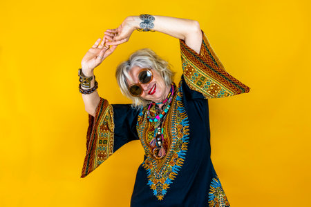 Funny portrait of mature woman. Beautiful lady have fun dressed with seventies costume. Mature woman...