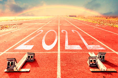2022 New Year celebration on the racing lane starting block and rainbow. New Year arrival conceptの写真素材