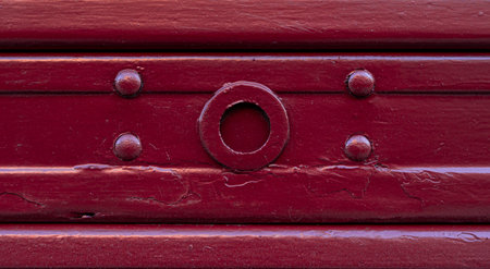 close-up of a wooden door panel texture with scratches - Old wood board pattern background painted in red colorの写真素材