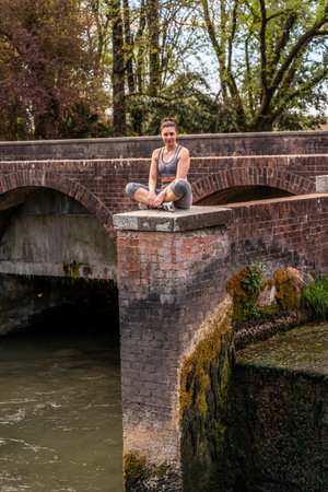 beautiful mature woman taking a relaxing moment on a brick deck outdoors - healthy lifestyle conceptの写真素材