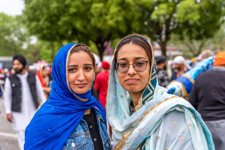 CREMONA, ITALY - APRIL 2022: young women of the Sikh monotheism religion in procession through the...
