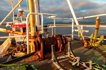 Abandoned vessel stranded on a beach on the Icelandic coast in the light of the midnight sunの写真素材