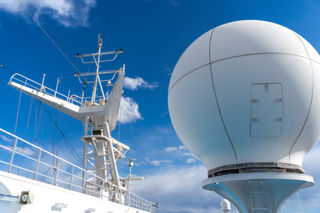 white antennas, radar and other communication and navigation equipment on the mast of shipの写真素材