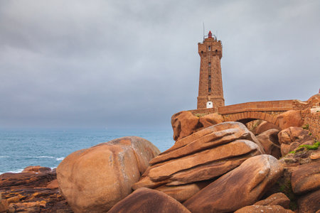 panoramic view of the famous Ploumanach lighthouse among the giant pink boulders in Brittany. Concept of wonders in the worldの写真素材