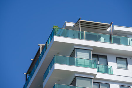 Penthouse, located in a new residential building, with a glass green fence.の写真素材