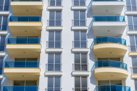 View of the facade of a new multi-apartment high-rise building. Detail of a modern residential complex.の写真素材