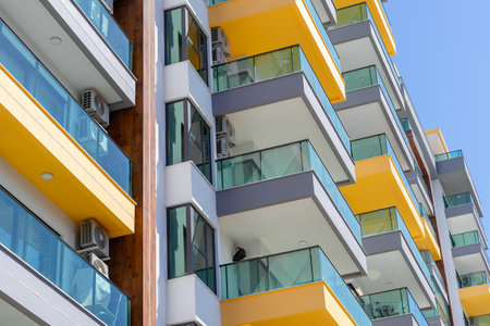 Part of a new luxury high rise residential building with large balconies and glass railings.の写真素材