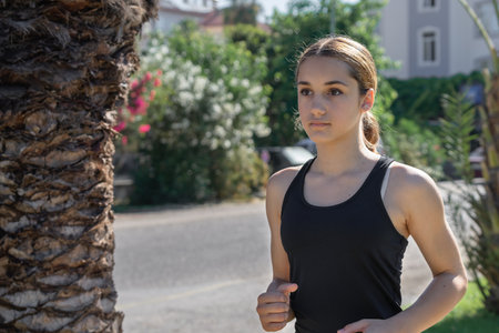Young girl in sportswear doing jogging. healthy lifestyle.の写真素材