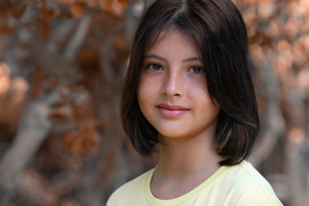 Close-up portrait of a cheerful teenage girl. autumn colors.の写真素材