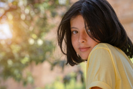 Close-up outdoor portrait of a cute young girl. Beautiful teen girl posing for the camera.の写真素材