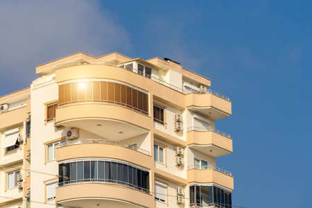 Exterior of a modern apartment building against a blue sky with clouds. residential properties.の写真素材