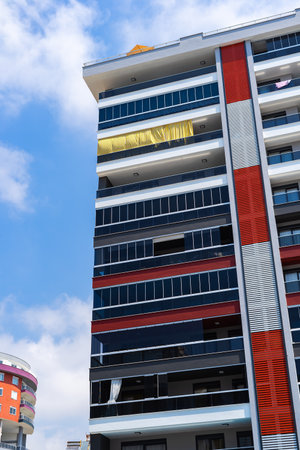 Exterior of a modern apartment building against a blue sky with clouds. residential properties.の写真素材