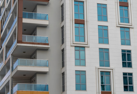 Modern high rise building. A number of identical windows. residential building.