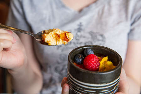 Berry creme brulee in the fine dining Japanese restaurant, with a traditional teapot container, a...
