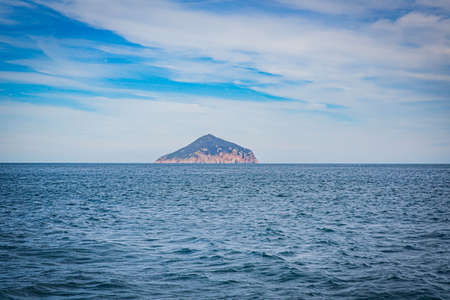 Isolated island seascape in Cruising tour view in the Bass Strait at Wilson Promontory Victoria Australia, with blue sea and skyの写真素材